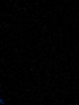 A stunning view of a star-filled night sky showcasing countless stars and a distant galaxy.