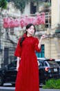 Elegant Woman in Red Ao Dai in Hanoi Streets