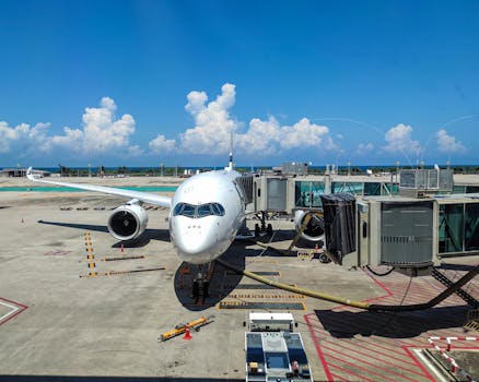 Jet plane at gate, Phuket International Airport, bright summer day.