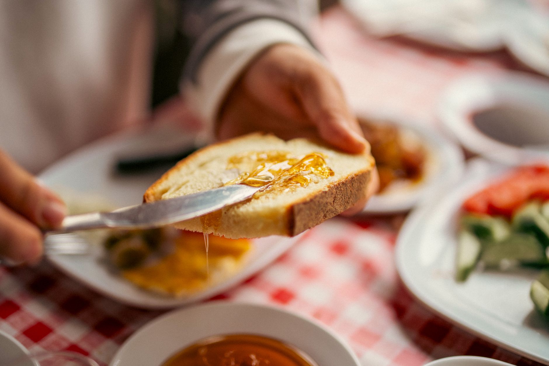A delicious breakfast scene with honey spread on bread, enhancing the morning meal.