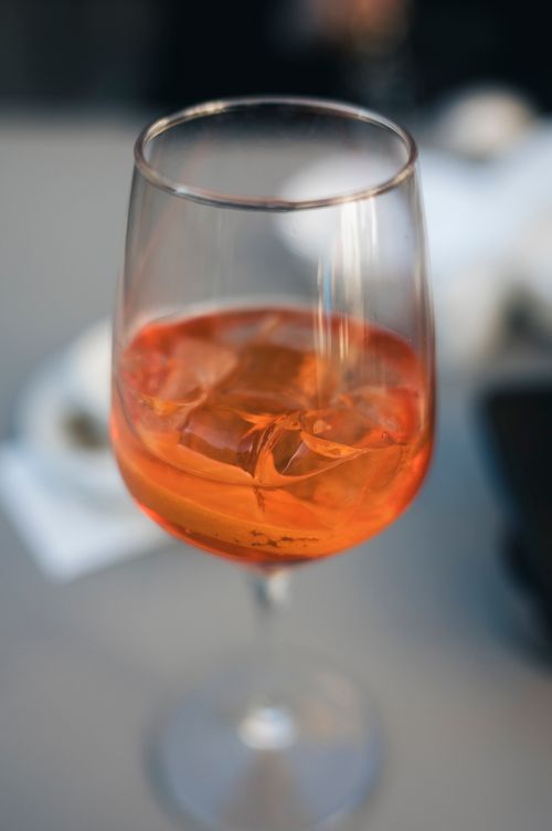 Free Close-up of an orange aperitif with ice cubes in a glass, indoors setting. Stock Photo
