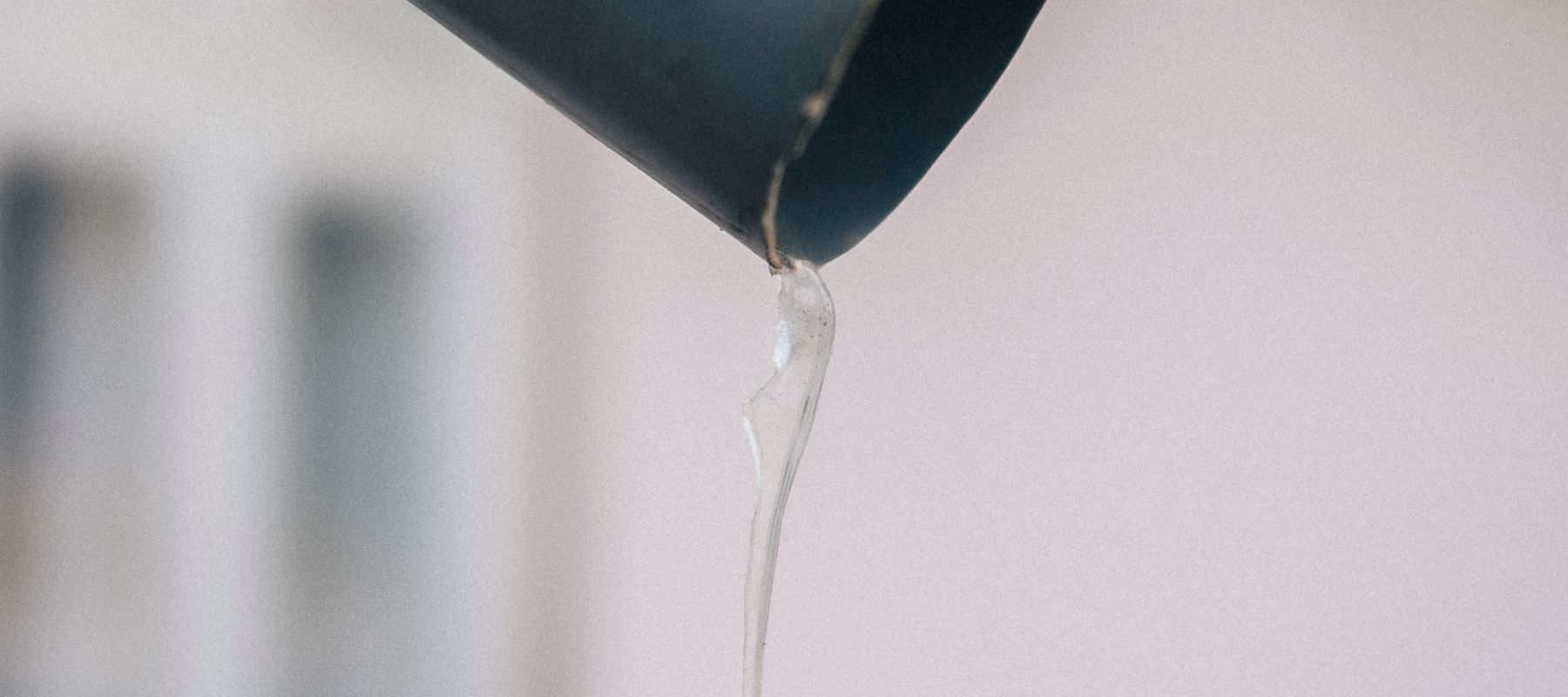 Icicle hanging from a metal gutter