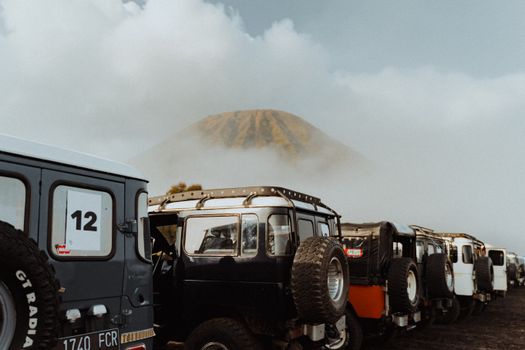 A line of adventure jeeps near the iconic Mount Bromo in East Java, Indonesia.