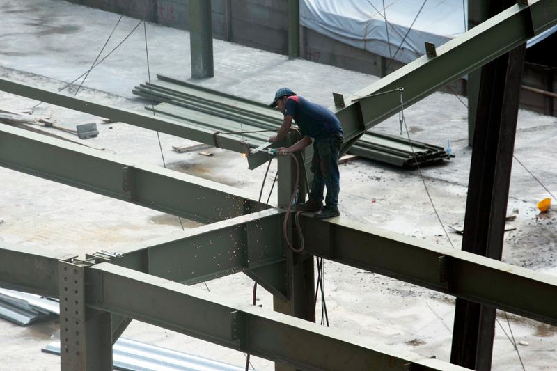 Construction worker welding steel beams