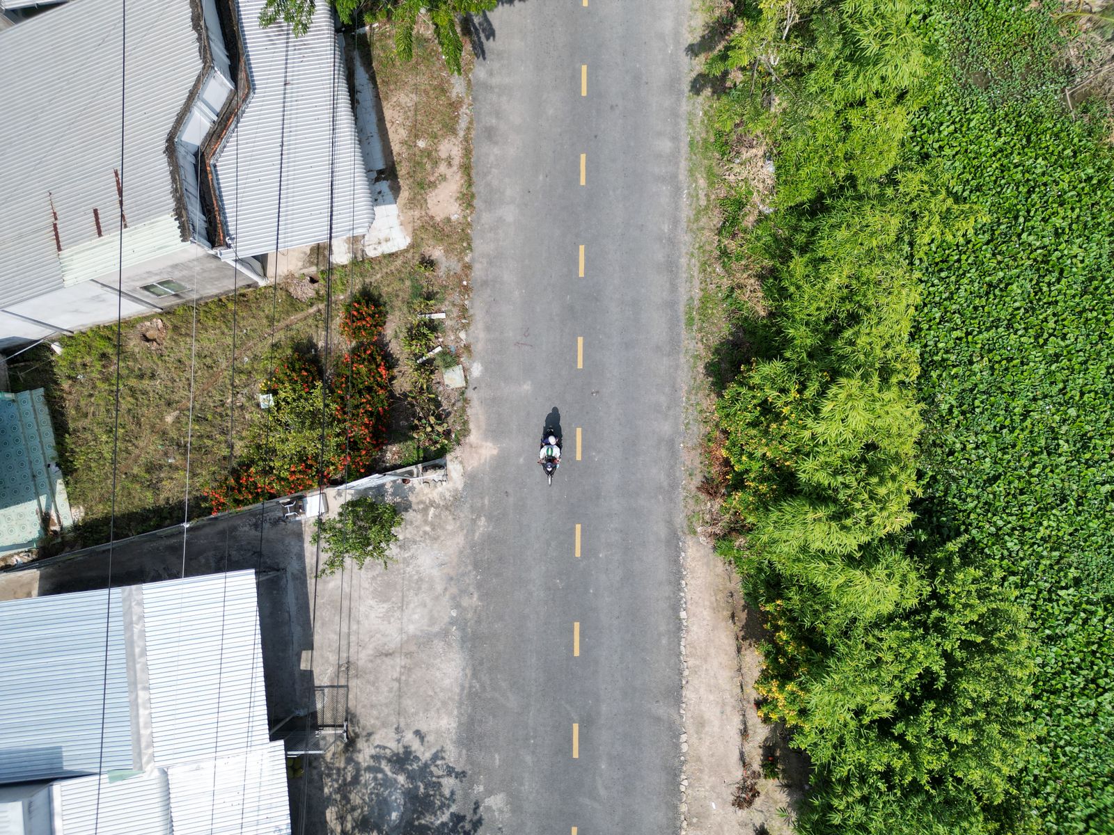 Aerial view of motorbike on rural Vietnamese road showing why packing light matters on the Ha Giang Loop