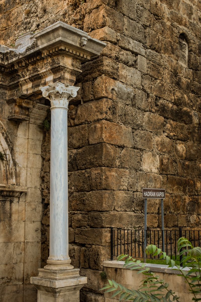 Marble column and stone wall of Hadrian's Gate (Hadrian Kapısı) in Antalya