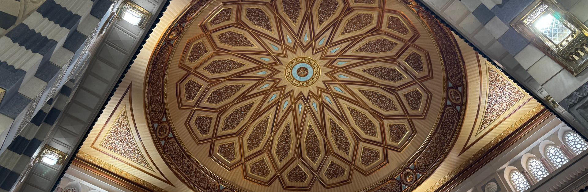 Detailed view of the ornate ceiling dome in a Medina mosque showcasing Islamic architecture.