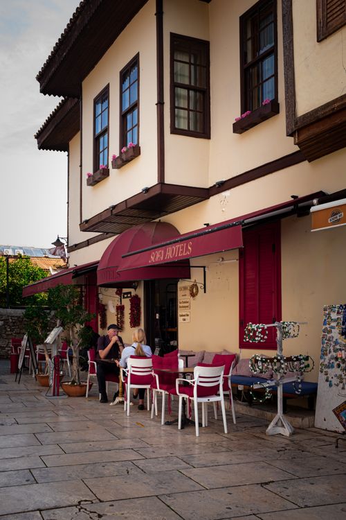 Free Cozy outdoor cafe at beautiful Mediterranean hotel showcasing traditional architecture. Stock Photo