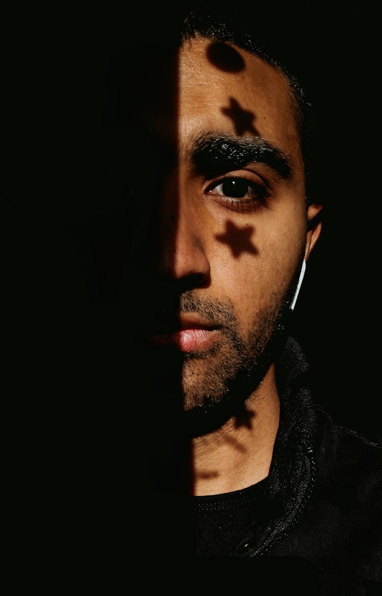 Man With Star And Circle Shadow On Face Wearing Black Crew Neck Shirt