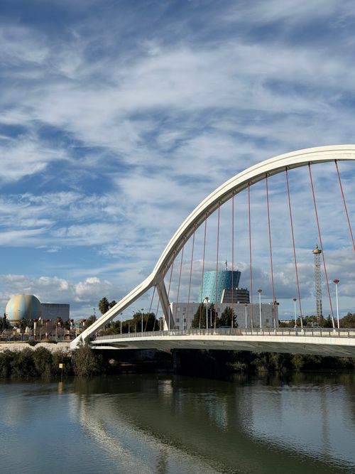 Free Contemporary suspension bridge with skyline and clear sky. Stock Photo