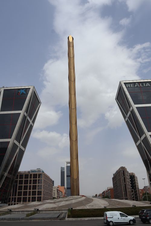 Free View of the golden Obelisco between the iconic leaning Puerta de Europa Towers in Madrid, Spain. Stock Photo