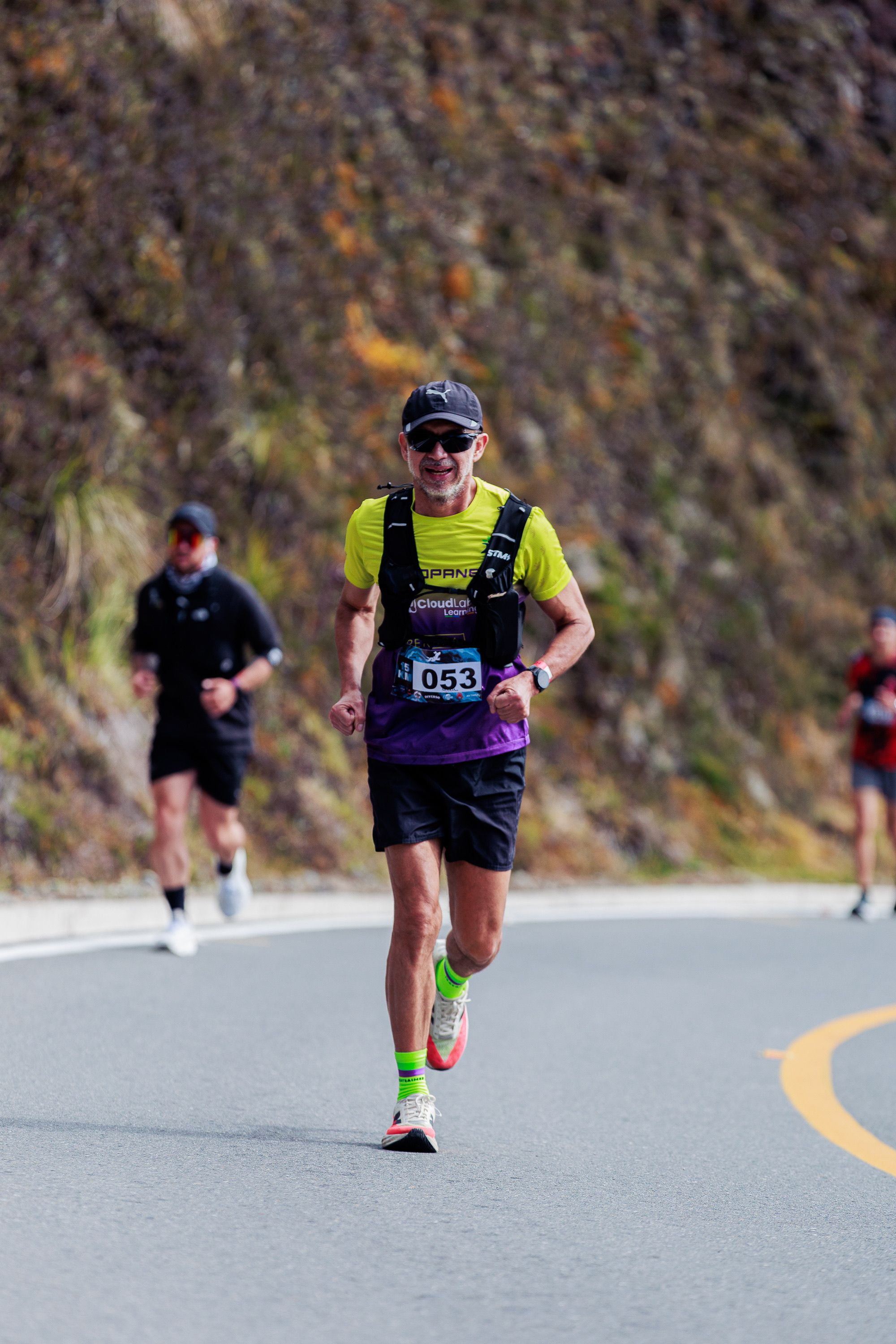 Energetic Runner Celebrating on Mountain Road · Free Stock Photo
