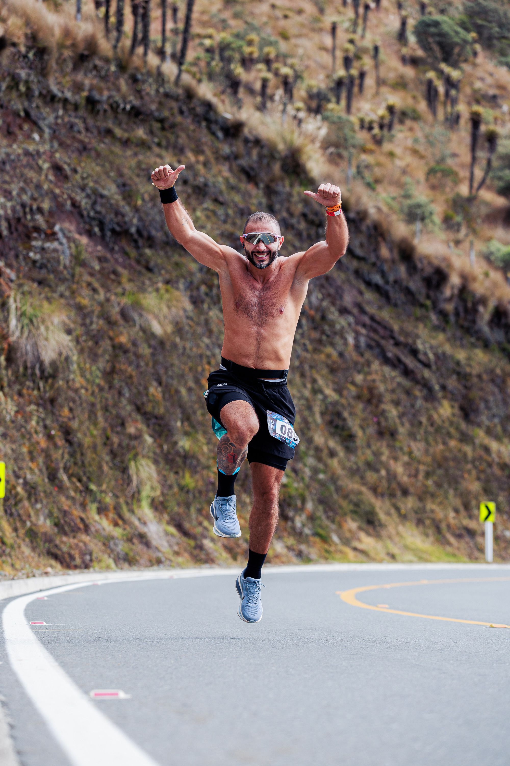 Energetic Runner Celebrating on Mountain Road · Free Stock Photo