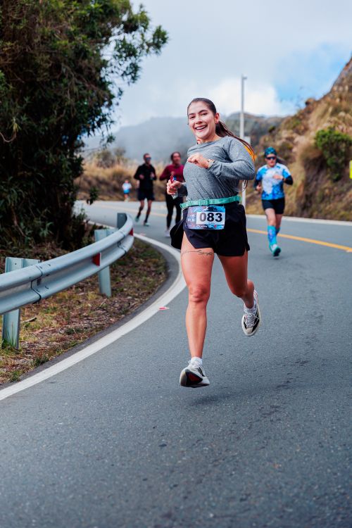 Smiling Runner Smiling Runner in Mountain Road Marathon Race · Free Stock Photo
