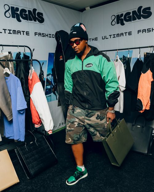 Free Man in trendy streetwear shopping at stylish urban fashion pop-up boutique. Stock Photo