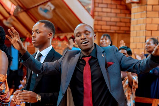 Young men in suits express joy and spirituality during a vibrant church celebration.