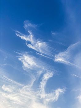 A calming view of a clear blue sky featuring delicate cirrus clouds, evoking a sense of peace and freedom.
