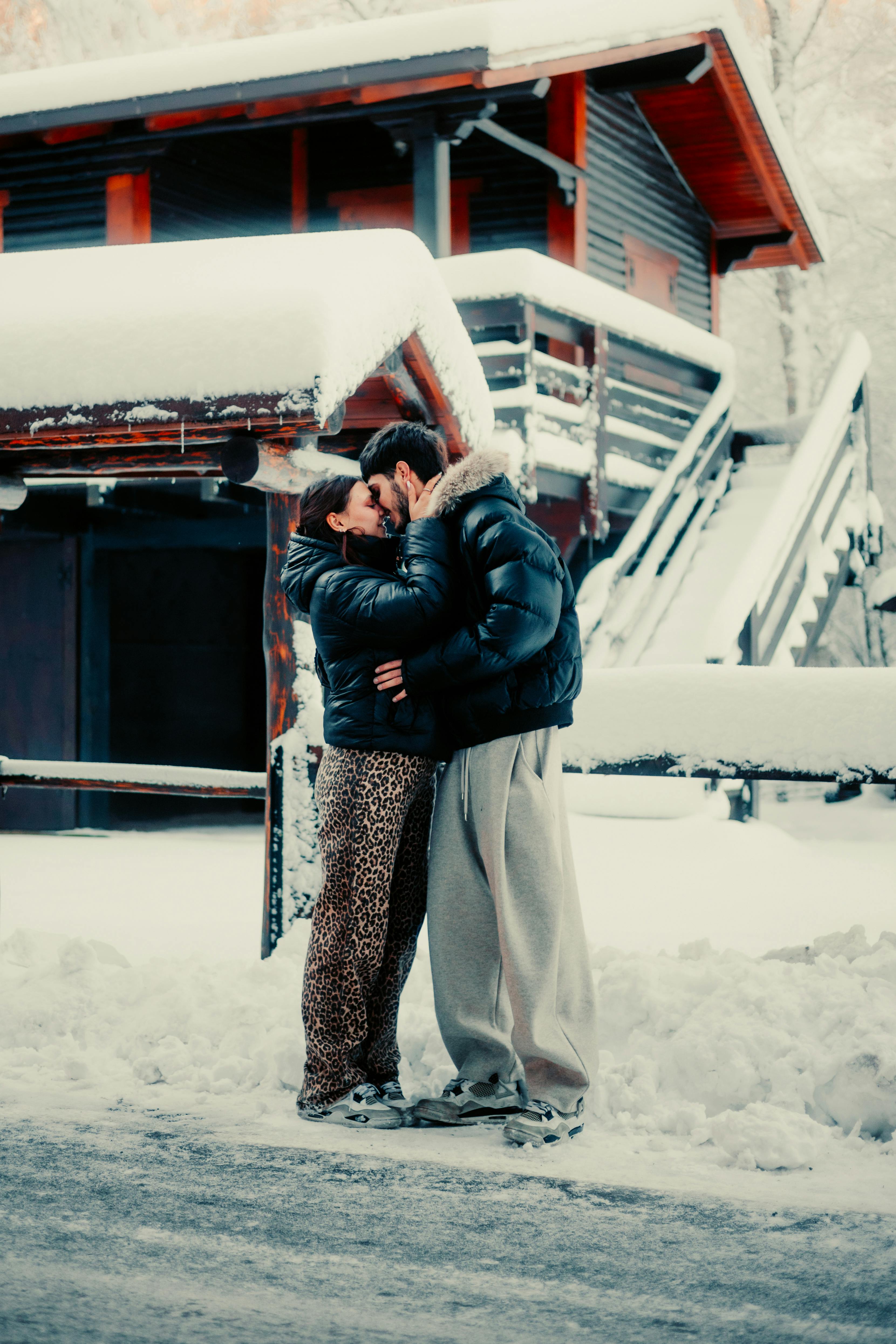 Loving couple in warm embrace before snowy view, symbolizing tender aftermath and deep connection