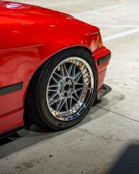 Detailed shot of a red sports car wheel with polished alloy rims and sleek tire