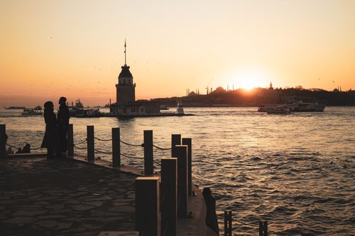Free Romantic silhouette at sunset by the iconic Maiden's Tower in İstanbul. Stock Photo