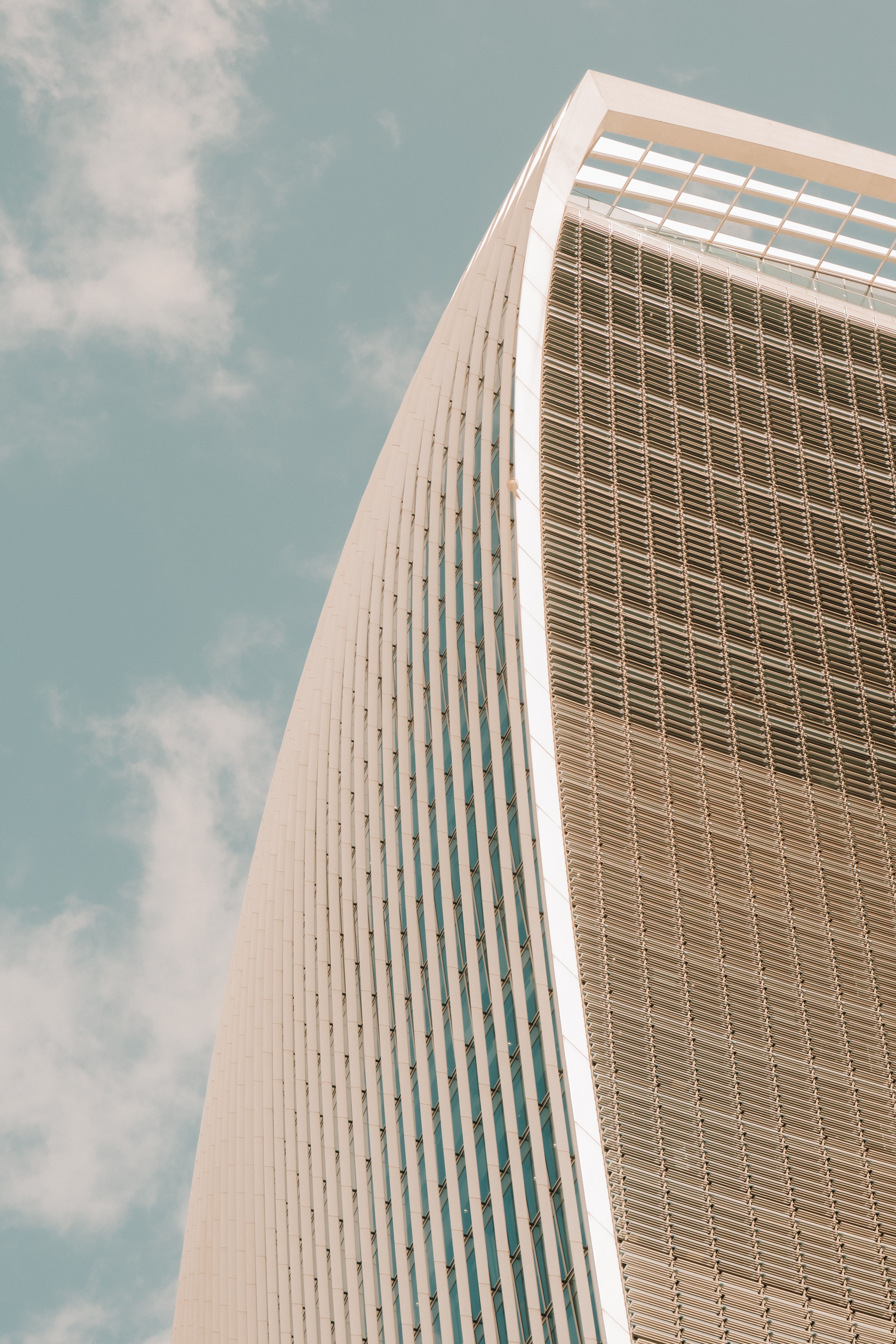 Minimalist view of London's Walkie Talkie building with a clear sky.