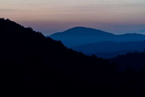 Free Experience the tranquil beauty of a sunset over Asheville's Blue Ridge Mountains. Stock Photo