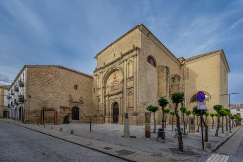Free View of a historic church in Baeza, Andalucía, featuring ornate architecture and a clear blue sky. Stock Photo
