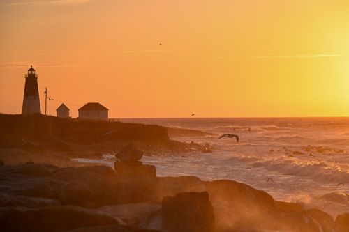 Free Captivating sunrise at Point Judith Lighthouse in Narragansett, Rhode Island, with vibrant orange hues. Stock Photo