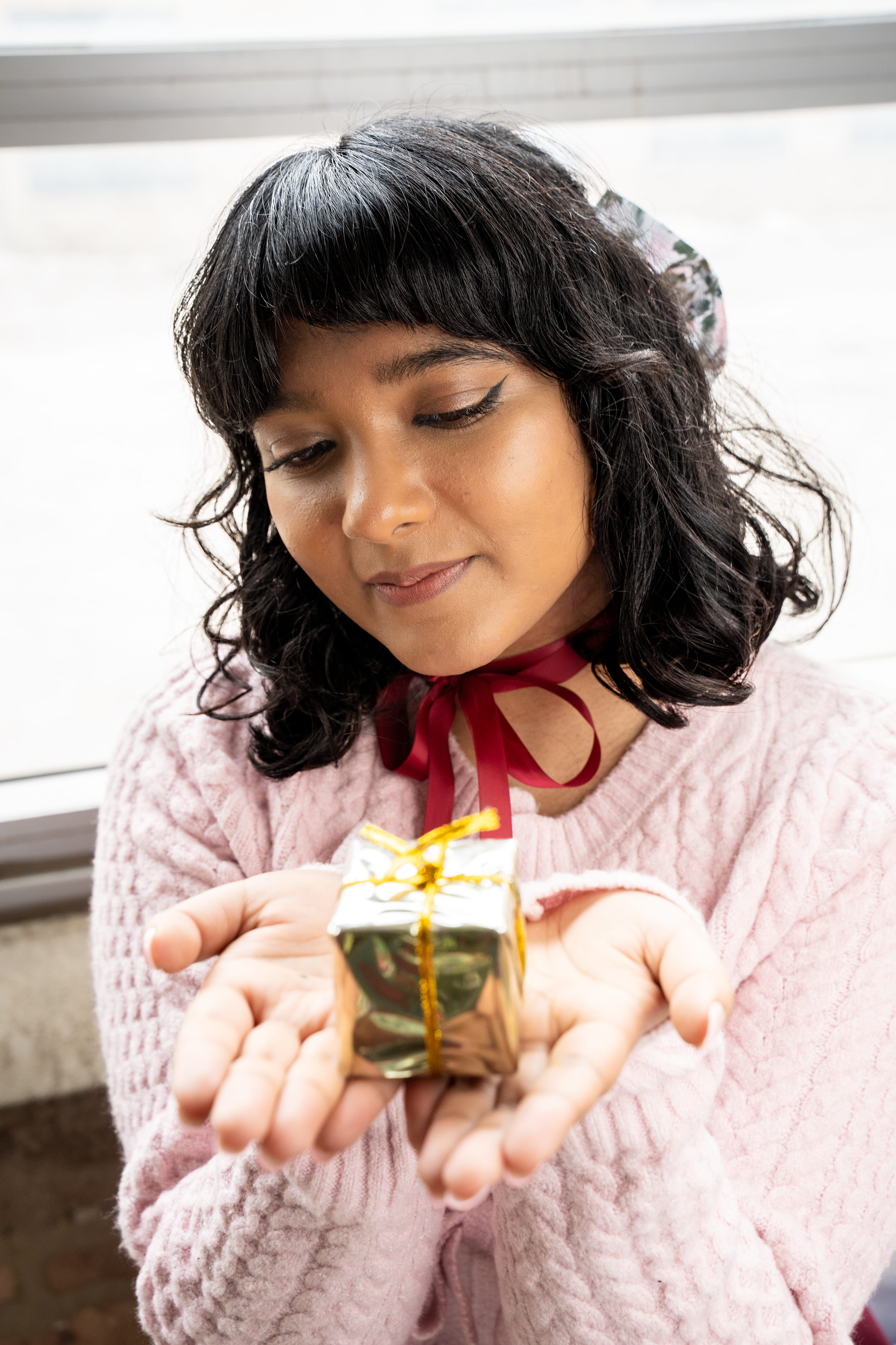 Woman Holding a Small Gift Box with a Bow · Free Stock Photo