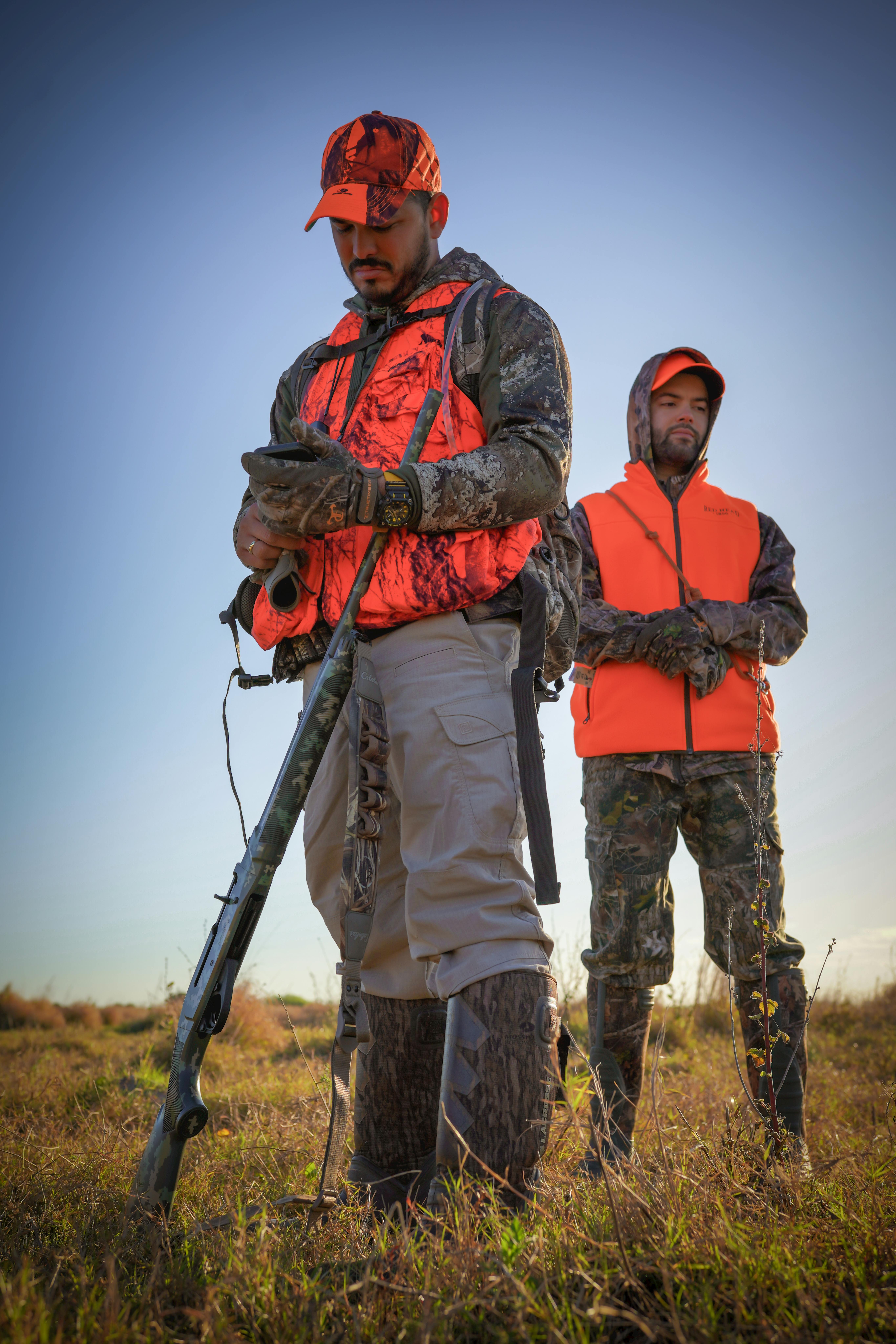 Two hunters in protective gear ready for an outdoor adventure in Florida.