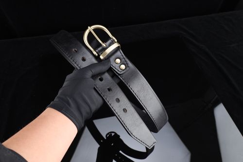 Free Stylish black leather belt with gold buckle, ideal for fashion accessories and handmade gift ideas. Stock Photo