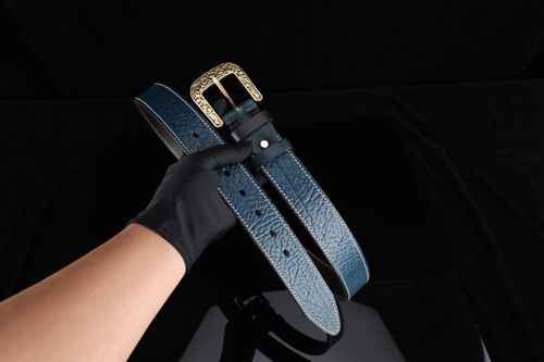 Free Premium blue leather belt with a decorative buckle, ideal for gifts and fashion accessorizing. Stock Photo