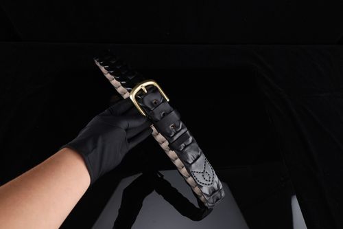 Free Stylish black leather belt with gold buckle, perfect for fashion accessories. Stock Photo