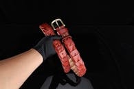 Elegant Red Leather Belt with Gold Buckle in Hand