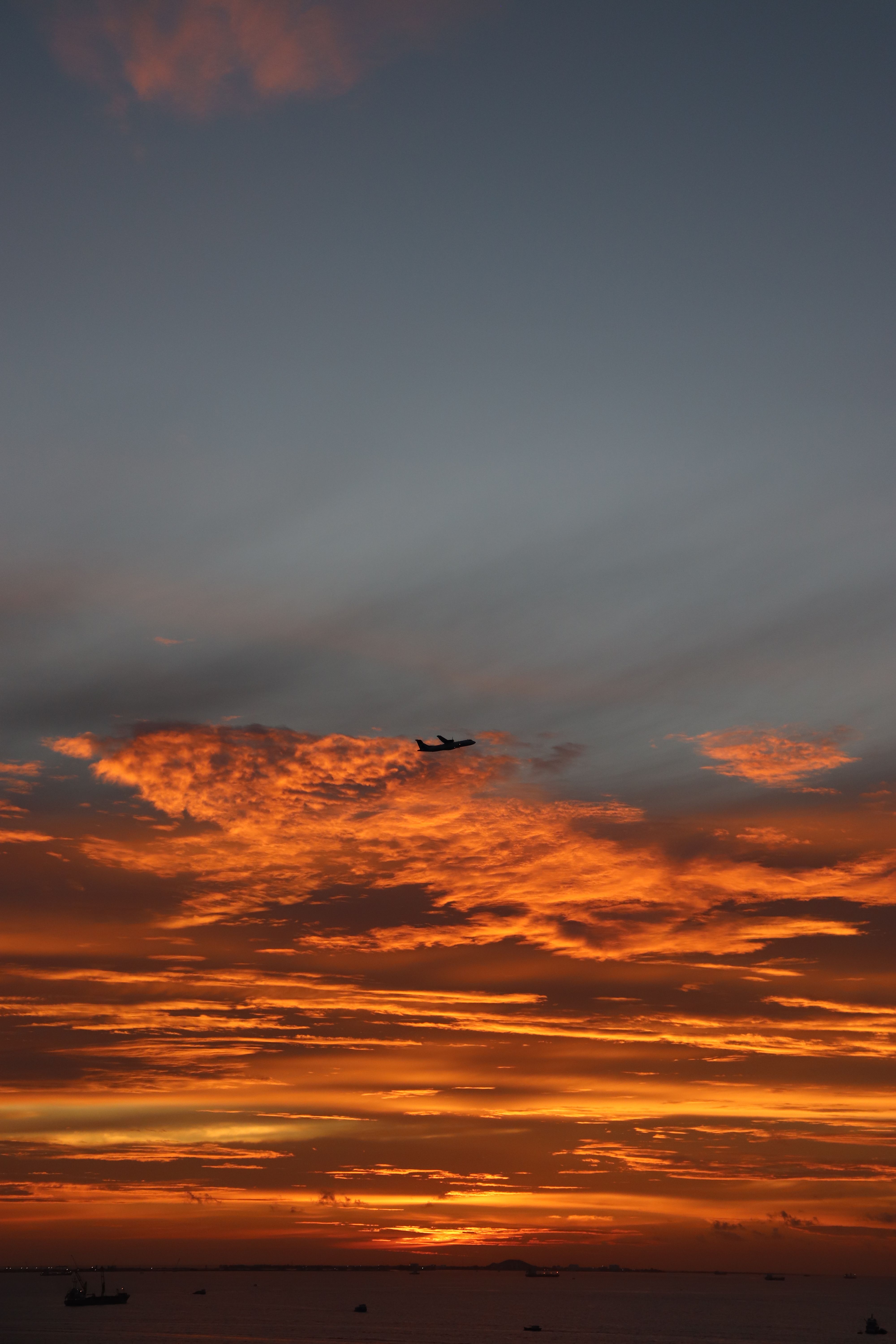 Airplane Silhouette Against Vibrant Sunset Sky · Free Stock Photo