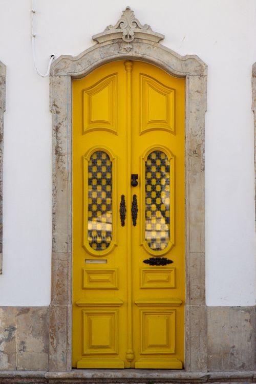 Free Charming yellow door showcasing Portuguese architecture in Olhão, ideal for travel and design inspiration. Stock Photo