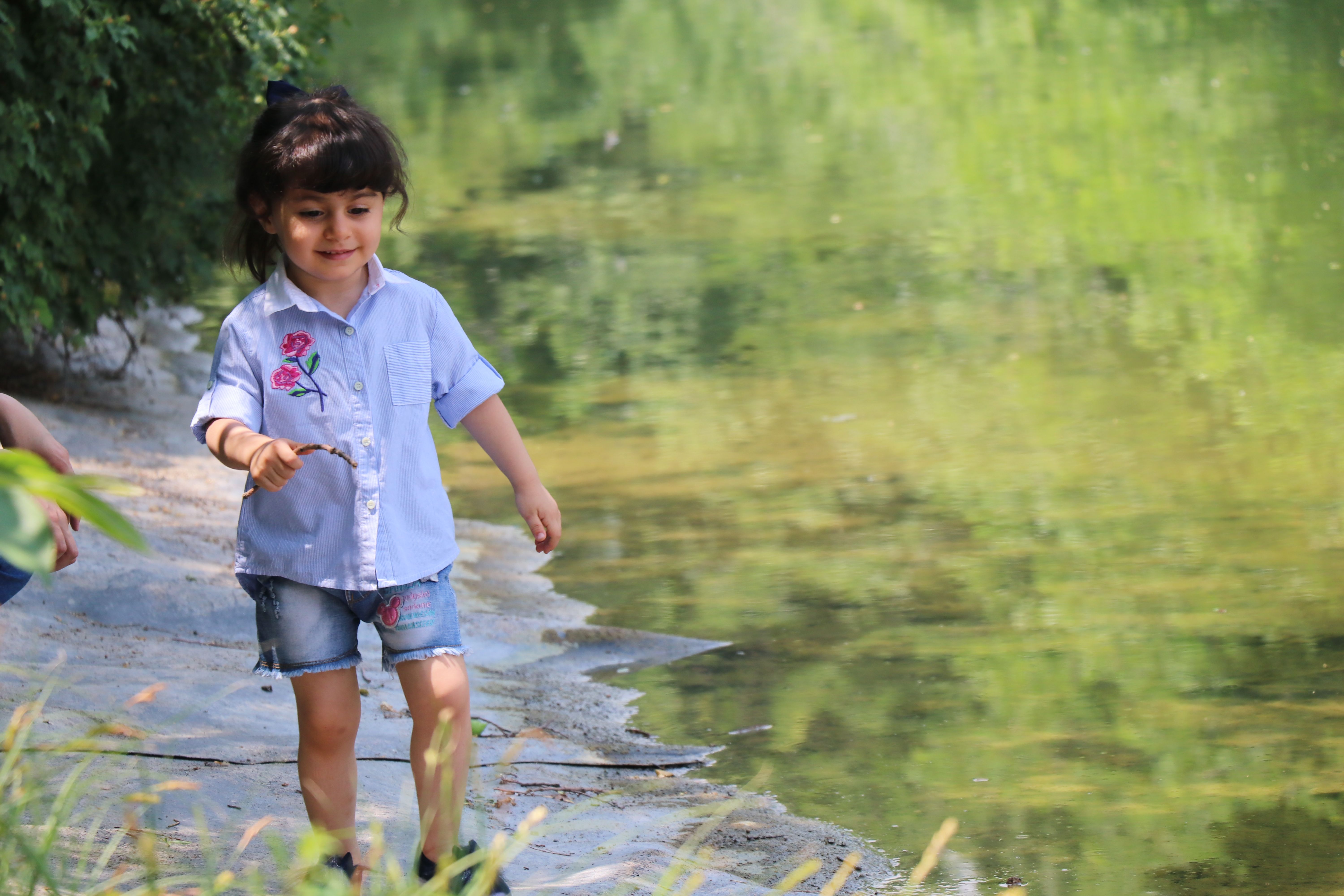Little Girl Exploring by the Riverside · Free Stock Photo