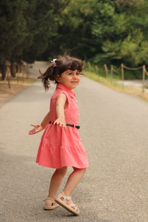 Joyful Girl in Pink Dress Dancing Outdoors · Free Stock Photo