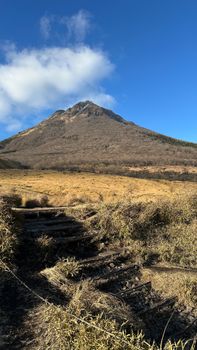 Breathtaking view of Mount Yufu with clear blue sky, showcasing nature's beauty in Japan's autumn.