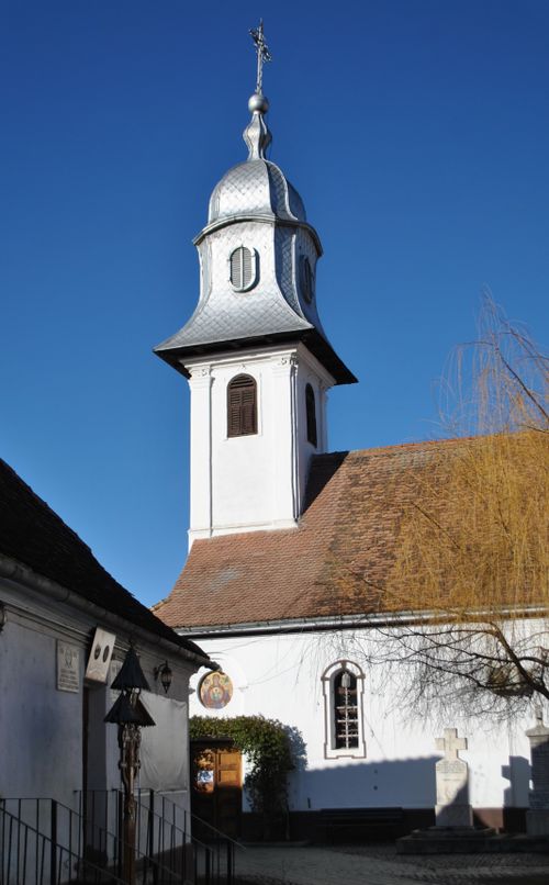 Free A historical church tower with a distinct silver dome set against a clear blue sky, capturing timeless architecture. Stock Photo