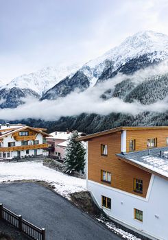 Snow-covered alpine village surrounded by majestic mountains in Soelden, Austria.