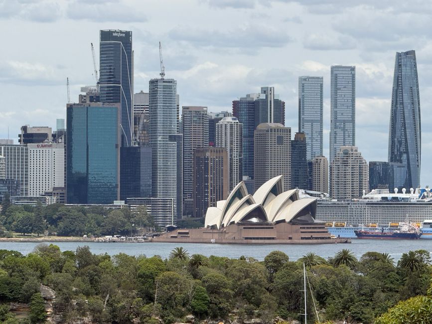 Scenic view of the Sydney Opera House with Sydney skyline in the background.