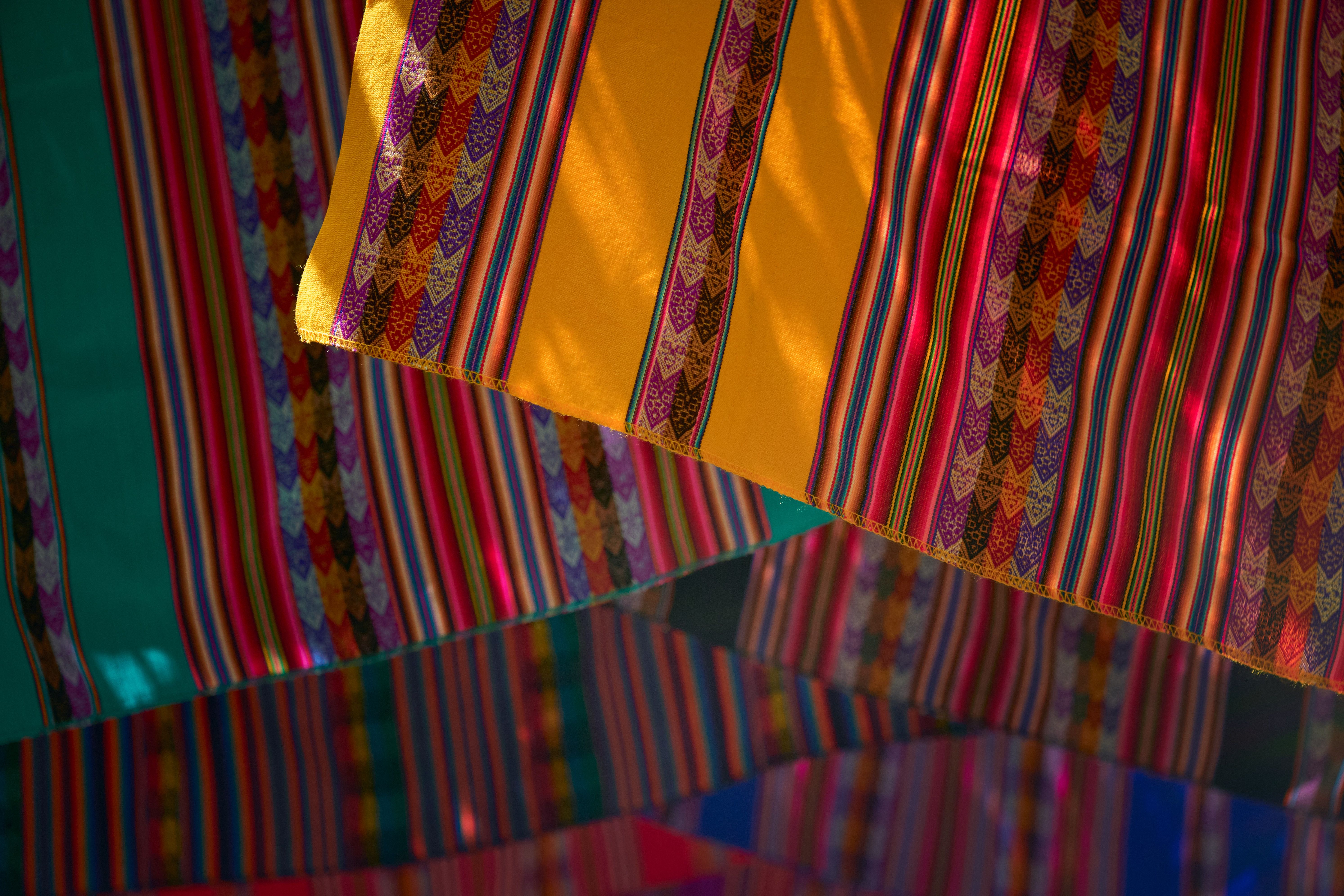 Colorful Traditional Fabric with Stripes and Patterns · Free Stock Photo