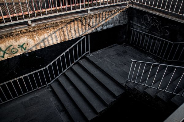 Brutalist concrete stairs under harsh light at night — photo by Van Mailian on Pexels