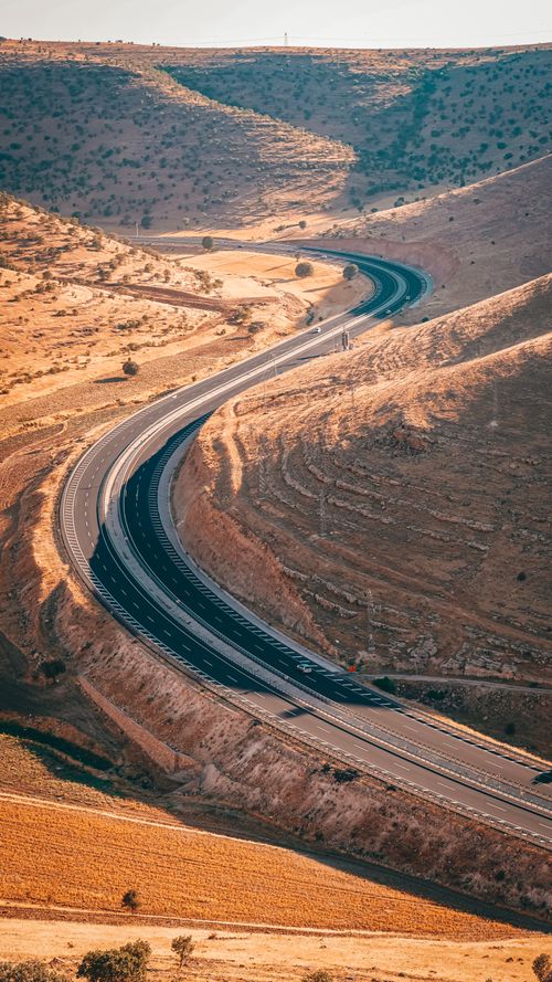 Free Aerial view of a winding road through the picturesque hills of Diyarbakır, Türkiye. Stock Photo