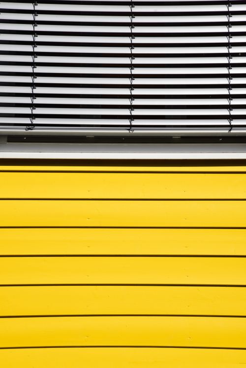Free Creative design of yellow wall with horizontal metal blinds in Freiburg, Germany. Stock Photo