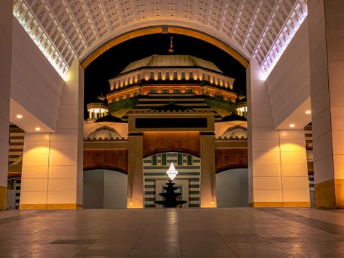 Free Stunning view of a mosque entrance beautifully lit with warm lighting at night. Stock Photo