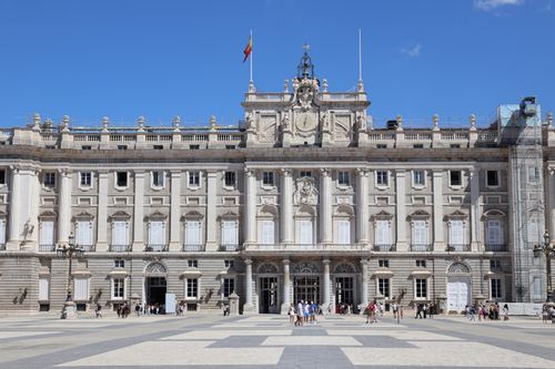 Free A clear day at the Royal Palace of Madrid with tourists in the plaza. Stock Photo