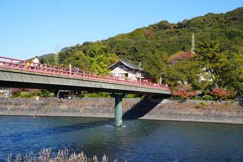 Free Charming scene of a bridge in Uji, Kyoto with lush green hills and a serene river. Stock Photo