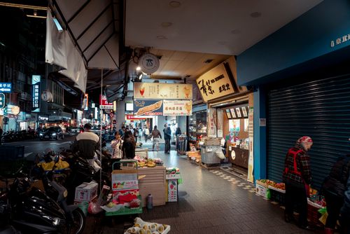Free Bustling night market scene in Taipei, Taiwan, with vendors and locals shopping and dining. Stock Photo